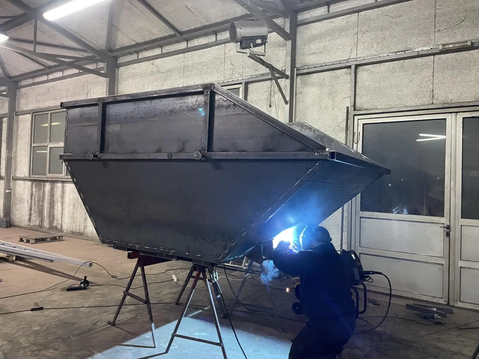 Welding a custom steel skip bin in the workshop