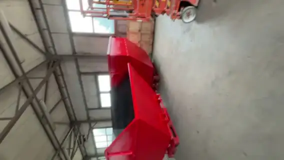 Close-up of a red powder-coated steel skip bin